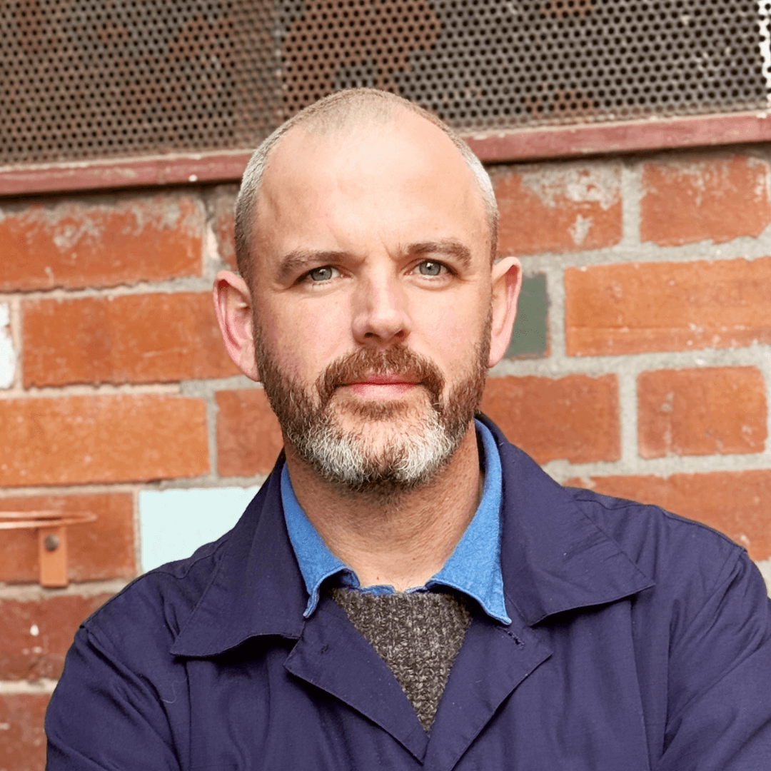 Josh, founder of The Bearded Man, standing inside the Prahran barbershop.