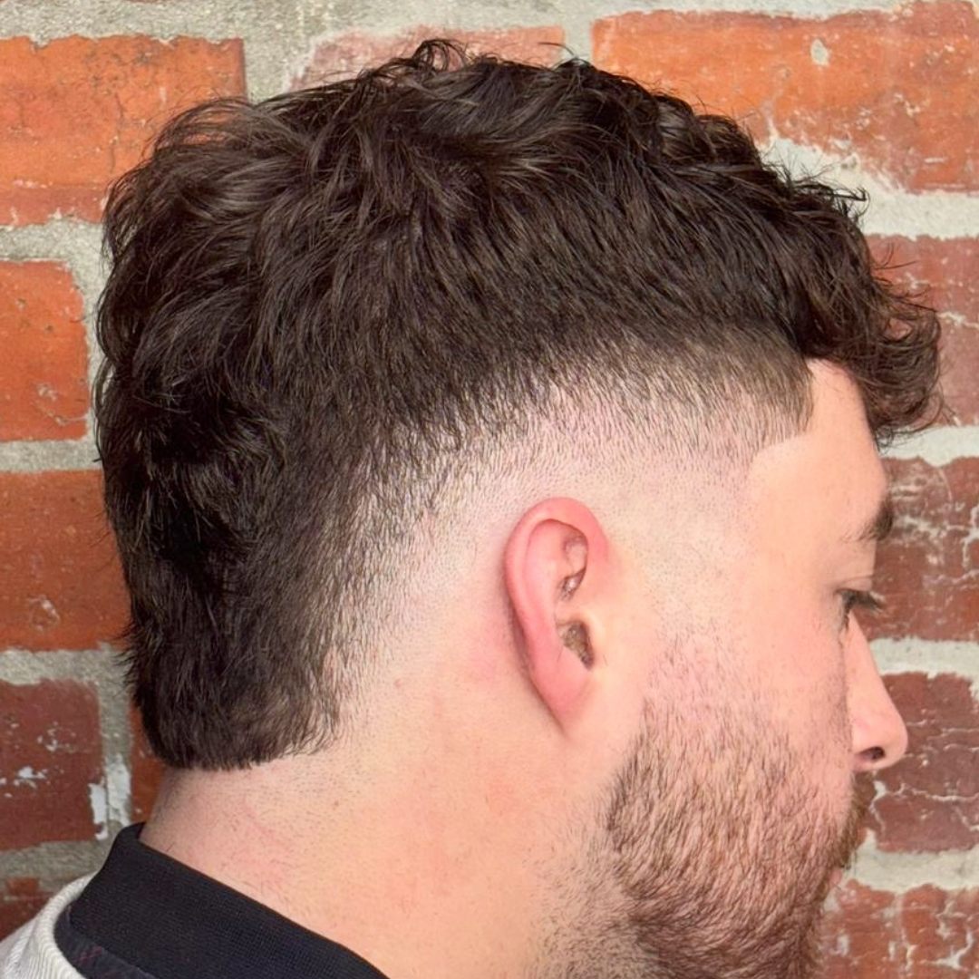 Barber blending a clean fade haircut in Melbourne